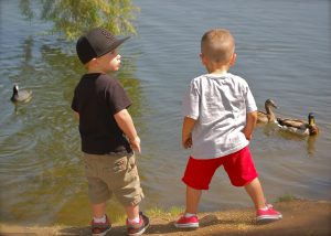 2 cute boys by water